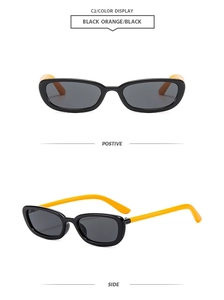 Detail view of oval sunglasses with black frame and vibrant orange temples in two angles