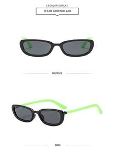 Detail view of oval black sunglasses with vibrant neon green temples and dark gray lenses