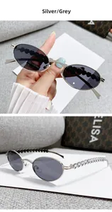 Detail of silver oval sunglasses featuring heart-shaped cutout and rhinestone accents