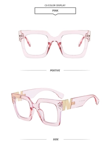 Detailed side view of pink transparent square glasses frame with gold W metal ornament