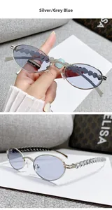Detailed view of oval metal sunglasses with sparkling rhinestones on the silver temples
