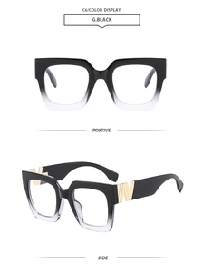 Detail view of large rectangular gradient black frame glasses with gold metal V-hinge