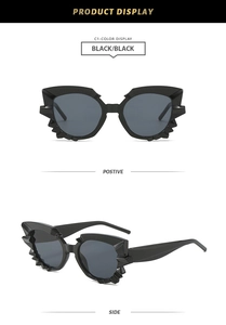 Close-up of black polygonal cat-eye sunglasses with unique jagged spike frame details