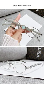 Detail of silver oval metal frame glasses with rhinestone bridge and heart cutout temples