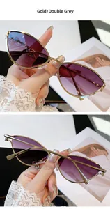 Détail de lunettes de soleil œil-de-chat avec monture dorée et verres dégradés violets