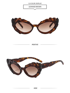 Detail view of leopard print cat eye sunglasses with wavy texture and brown gradient lenses