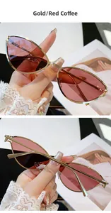 Détails de lunettes de soleil œil de chat dorées avec verres café rouge élégants
