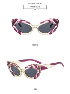 Cat eye sunglasses detail with purple frames and unique flame-shaped cutout on the side