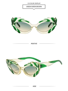 Detail view of green cat eye sunglasses with flame-shaped frame and gradient lenses