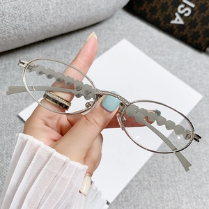 Silver oval sunglasses with rhinestone heart and cloud shaped mirror frame elements