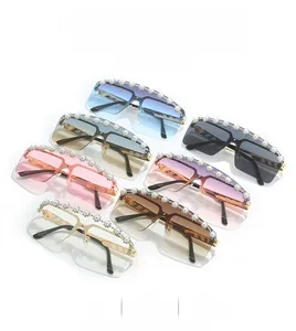 Detail of rimless square sunglasses with pearl and rhinestone accents on the frame