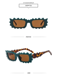 Detail view of green scalloped frame sunglasses with tea lenses and tortoise temples
