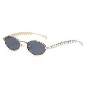 Fashionable oval metal sunglasses with heart-shaped rhinestones on golden temples