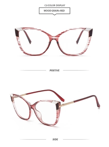 Detail view of cat eye glasses in red wood grain finish with slim metal temples