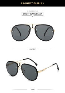 Detail view of black aviator sunglasses with gold metal accents and double bridge design