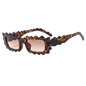 Irregular jagged edge sunglasses with tortoise texture and brown gradient lenses