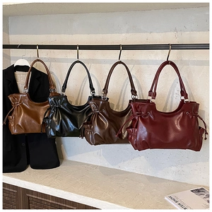 Detailed view of vintage textured tote bags with pleats and side pockets in four colors