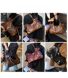 Detail view of large leather hobo bags in vintage brown and black on urban background