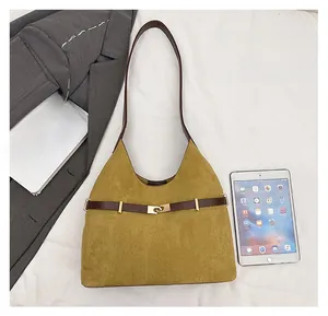 Detailed top view of large yellow suede tote bag showing capacity for daily essentials