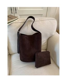 Detail of dark brown suede bucket bag set with woven strap and small matching pouch
