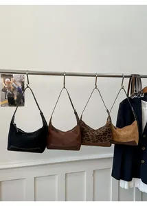 Multiple hobo bags in suede and leather, featuring classic crescent shapes and rich colors