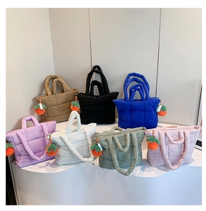 Quilted nylon tote bags displayed in seven colors with fluffy carrot charms