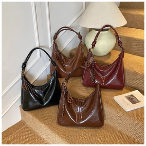 Detail of high-gloss oil wax leather shoulder bags in four vintage colors with knot straps