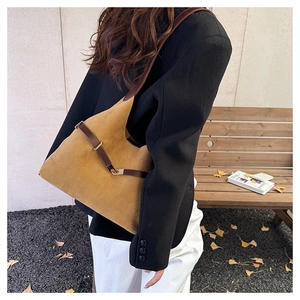 Brown suede tote bag side view showing high-quality leather straps and metallic buckle detail