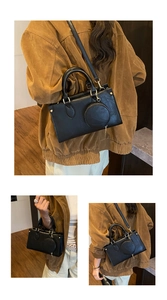Detail view of black matte leather handbag with gold hardware and small round coin purse