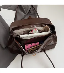 Top view of spacious deep brown tote interior showing zip pockets and wide storage