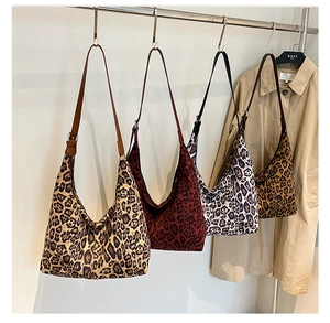 Detailed view of four leopard print hobo bags in various colors with leather straps