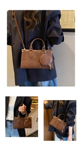 Detail of vintage brown shoulder bag with a small coin purse and golden hardware