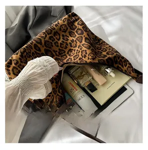 Spacious leopard print tote bag interior showing capacity for tablets and daily essentials
