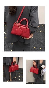 Detail of red leather tote bag with detachable round coin purse and gold hardware