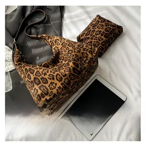 Macro view of leopard print tote bag with matching coin purse on a minimalist white fabric