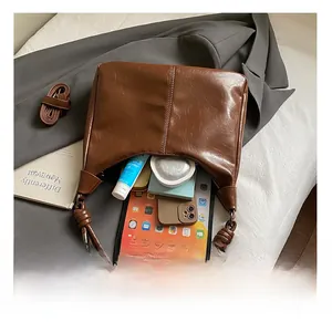Detailed interior of vintage brown tote bag showing capacity for tablets and cosmetics