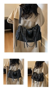 Detail of black Y2K shoulder bag featuring functional drawstrings and metal rivets
