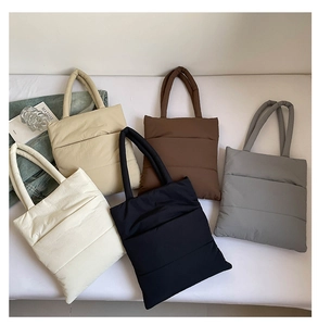 Flat lay view of quilted padded tote bags in five colors with soft cotton stuffing