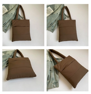 Macro detail of brown quilted puffer tote bag with stitched texture and nylon finish