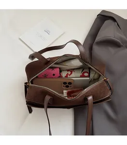 Interior view of brown suede baguette bag showing spacious capacity for daily essentials
