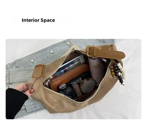 Top-down view showing interior space of the brown suede hobo bag with daily essentials