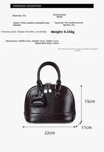 Vue détaillée du sac coquillage bordeaux avec dimensions et bandoulière réglable