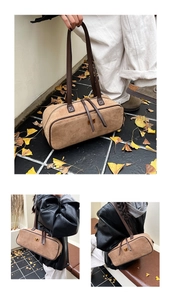 Detail of vintage khaki suede baguette bag with leather trim and gold hardware
