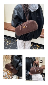 Detailed close-up of dark brown suede bag with elegant golden twist lock and retro design