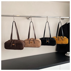 Detailed display of suede baguette bags in four colors with elegant metal locks