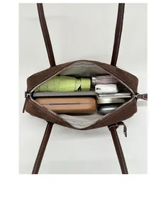 Spacious interior of brown suede tote bag showing capacity for umbrella and gadgets