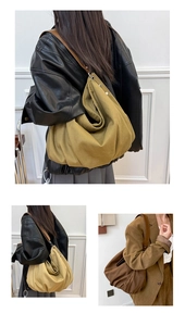 Detail of khaki and brown canvas tote bag with leather straps and metal rivets