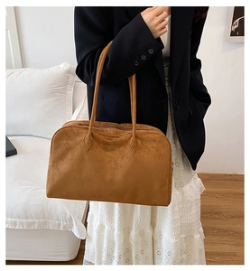Close-up of the textured dark camel suede tote bag with slim shoulder straps for women