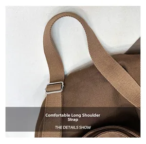 Detail view of the brown canvas tote bag featuring an adjustable sturdy shoulder strap