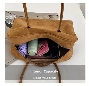Internal capacity of the suede Boston bag showing space for umbrella and daily items